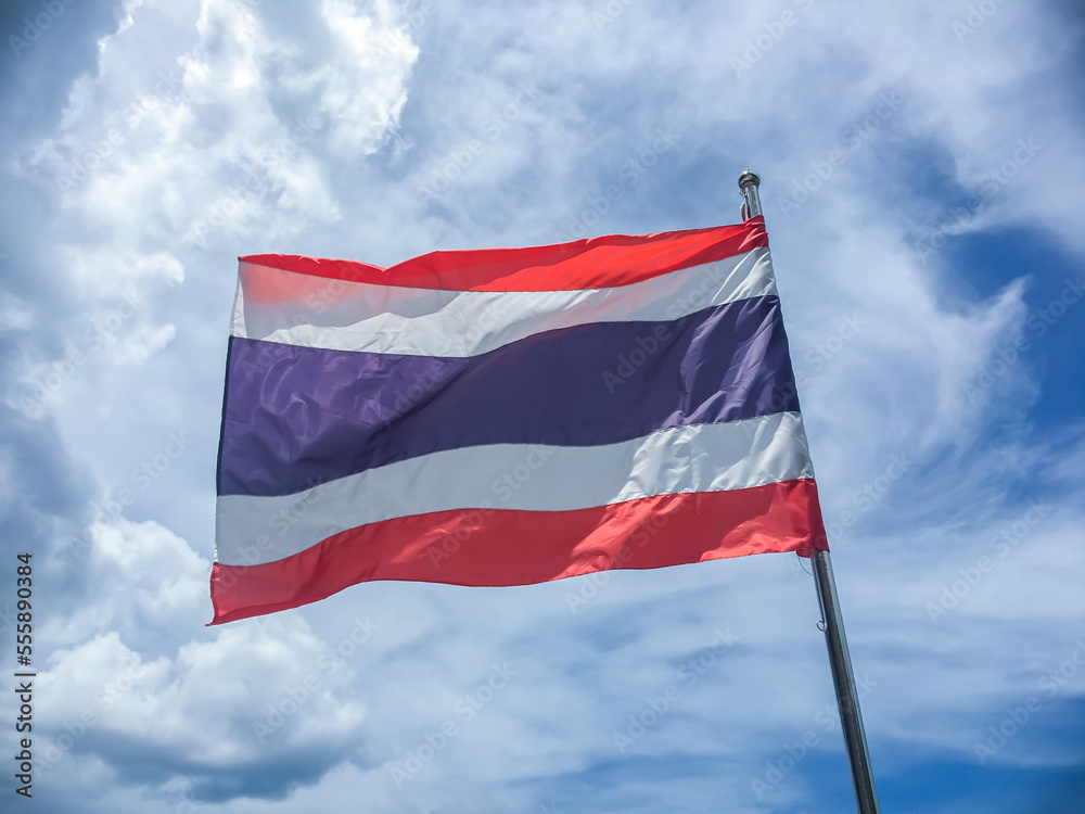 National flag of Thailand blowing in the wind on the blue sky. The flag of Thailand shows the color of red ,white and blue in five horizontal stripes which said to stand for nation-religion-king.