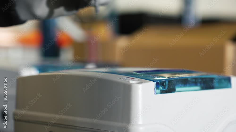 Hand of an engineer working on w machine with his screwdriver 