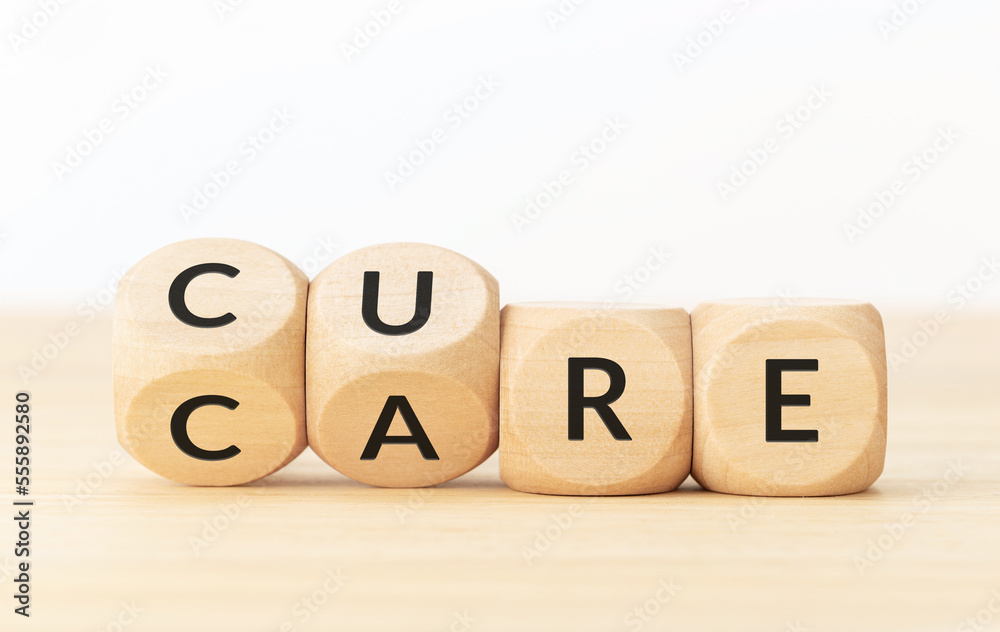 Care to cure concept.Text on wooden blocks and changing dices Care to cure concept.Text on wooden blocks and changing dices