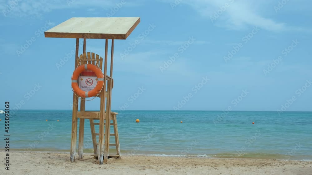 Empty wooden lifeguard station on sandy beach on ocean shore in summer Empty wooden lifeguard station on sandy beach on ocean shore in summer