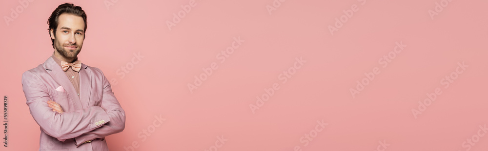 Confident host of event looking at camera isolated on pink, banner Confident host of event looking at camera isolated on pink, banner