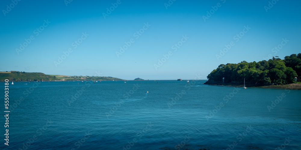 View across the busy water towards Plymouth from Mount Edgcumbe Country Park, Cornwall, UK
