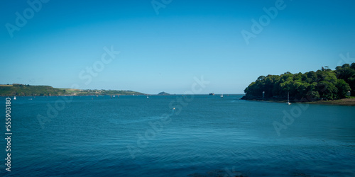 View across the busy water towards Plymouth from Mount Edgcumbe Country Park, Cornwall, UK
