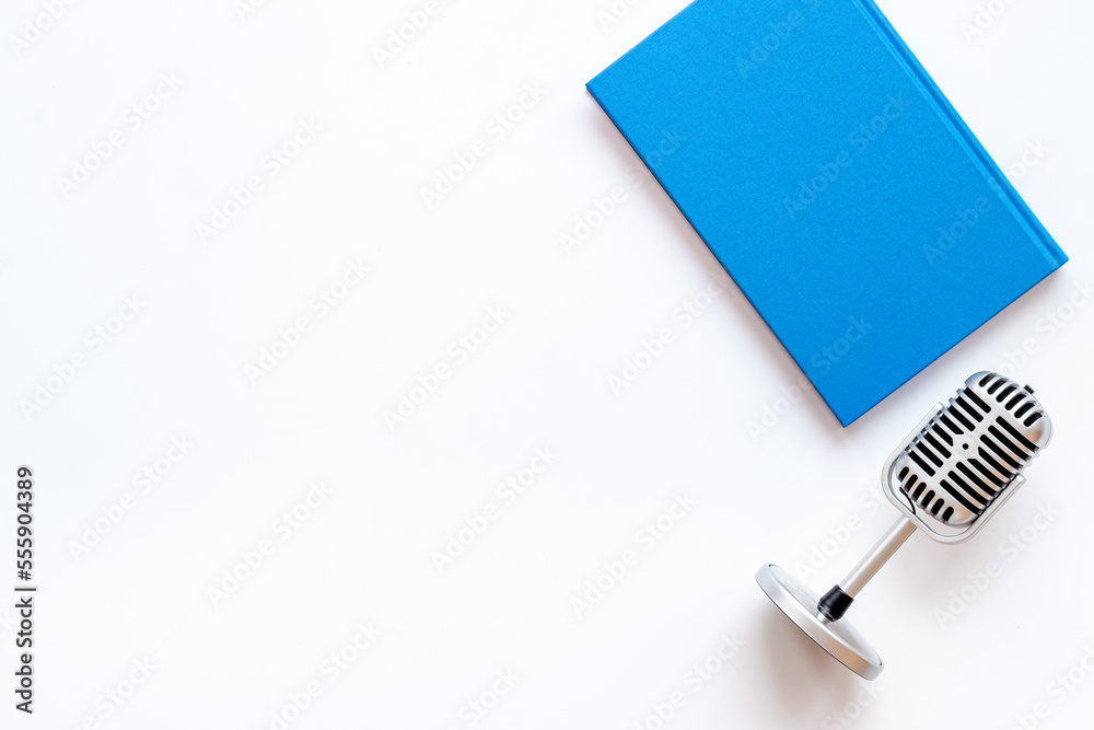 Flat lay of microphone and book. Record an audiobook or podcast concept Flat lay of microphone and book. Record an audiobook or podcast concept