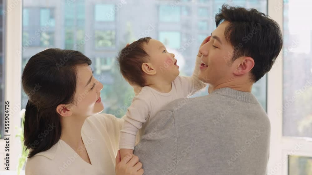 Young Chinese parents spending time with their baby Young Chinese parents spending time with their baby