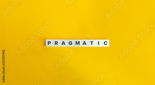 Pragmatic Word on Block Letter Tiles on Yellow Background. Minimal Aesthetics.
