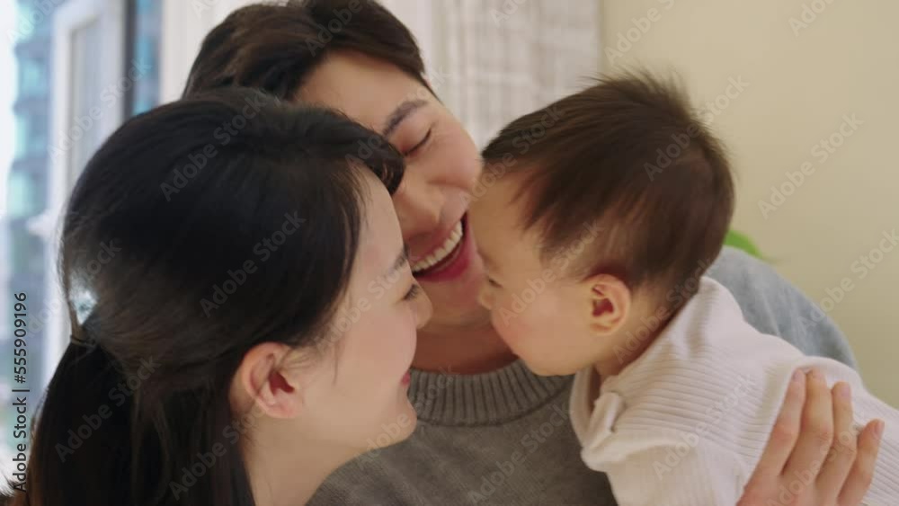 Young Chinese parents spending time with their baby Young Chinese parents spending time with their baby
