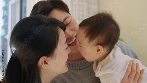 Young Chinese parents spending time with their baby