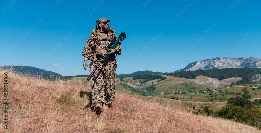 Army soldier holding a sniper rifle with scope and walking in the forest. war, army, technology and people concept. Army soldier holding a sniper rifle with scope and walking in the forest. war, army, technology and people concept.