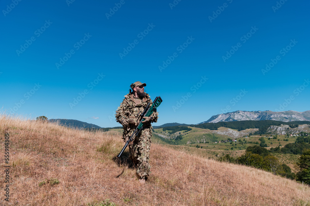 Army soldier holding a sniper rifle with scope and walking in the forest. war, army, technology and people concept. Army soldier holding a sniper rifle with scope and walking in the forest. war, army, technology and people concept.