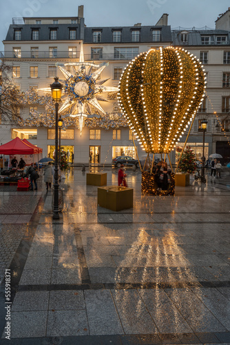 Paris, France - 12 22 2022: View of facade of Christian Dior Paris with christmas decoration in a rainy night photo