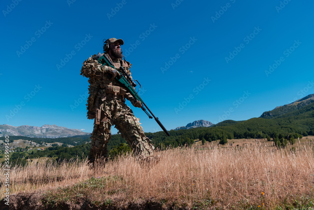 Army soldier holding a sniper rifle with scope and walking in the forest. war, army, technology and people concept. Army soldier holding a sniper rifle with scope and walking in the forest. war, army, technology and people concept.