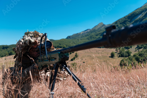 Army soldier holding sniper rifle with scope and aiming in forest. War, army, technology and people concept
