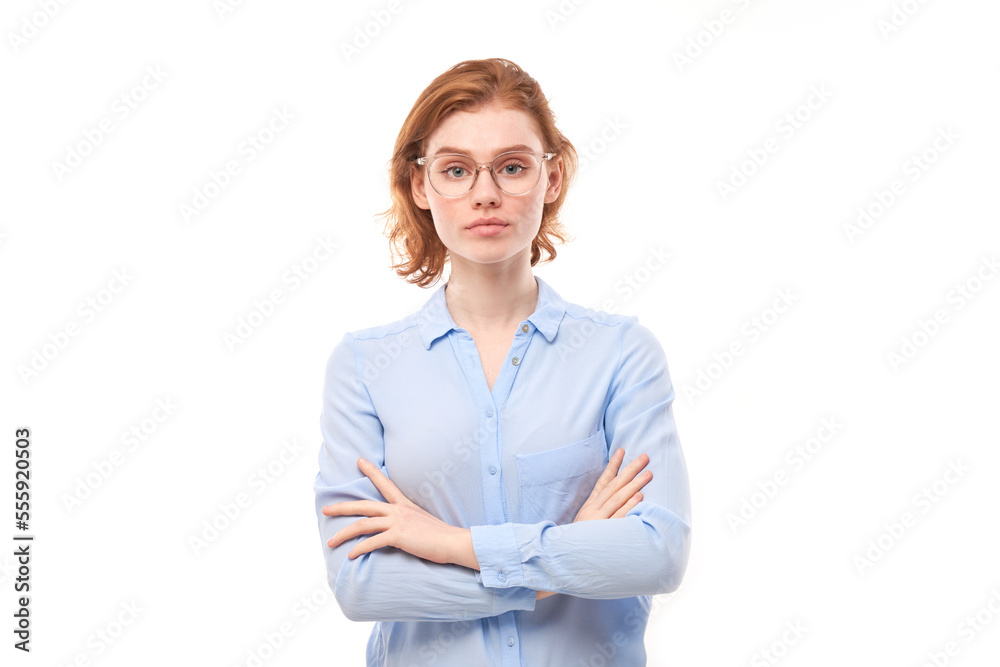 Portrait of attractive red-haired girl in business shirt and glasses smiling joyfully isolated on white studio background. Portrait of attractive red-haired girl in business shirt and glasses smiling joyfully isolated on white studio background.