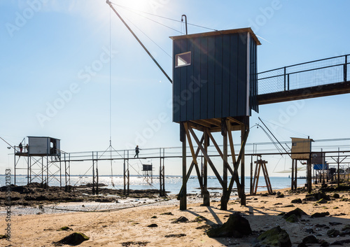 Low angle view of wooden fishing cabins with a large square lift net called 