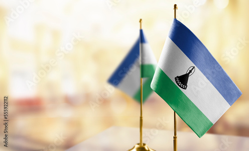 Small flags of the Lesotho on an abstract blurry background