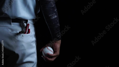 A baseball player pitcher with his baseball and baseball gloves