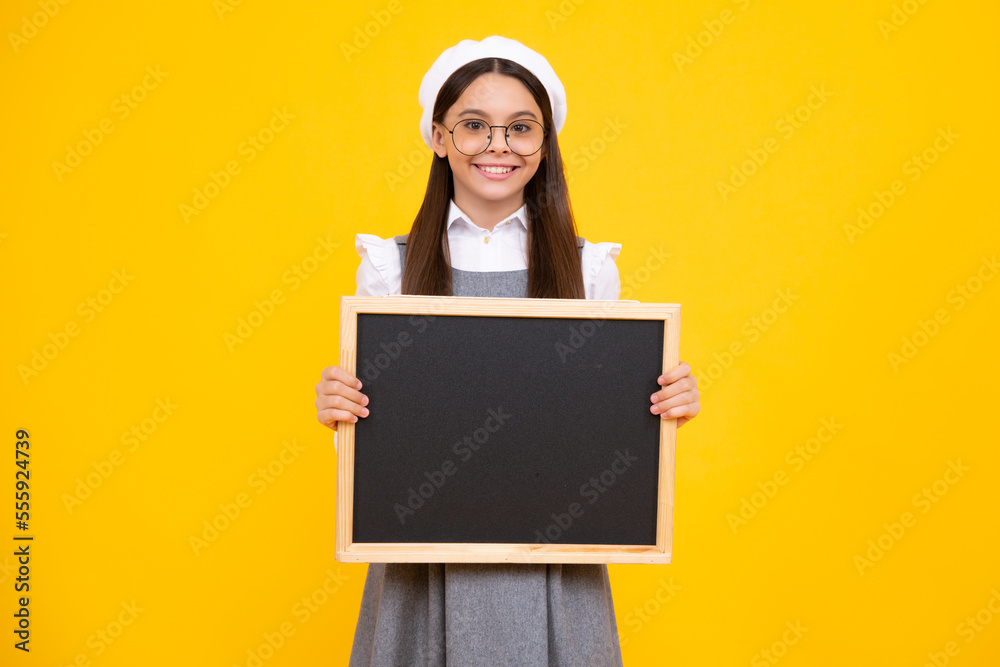 Teen schoolgirl hold blackboard. Child advertising. Back to school. Happy face, positive and smiling emotions of teenager girl. Teen schoolgirl hold blackboard. Child advertising. Back to school. Happy face, positive and smiling emotions of teenager girl.