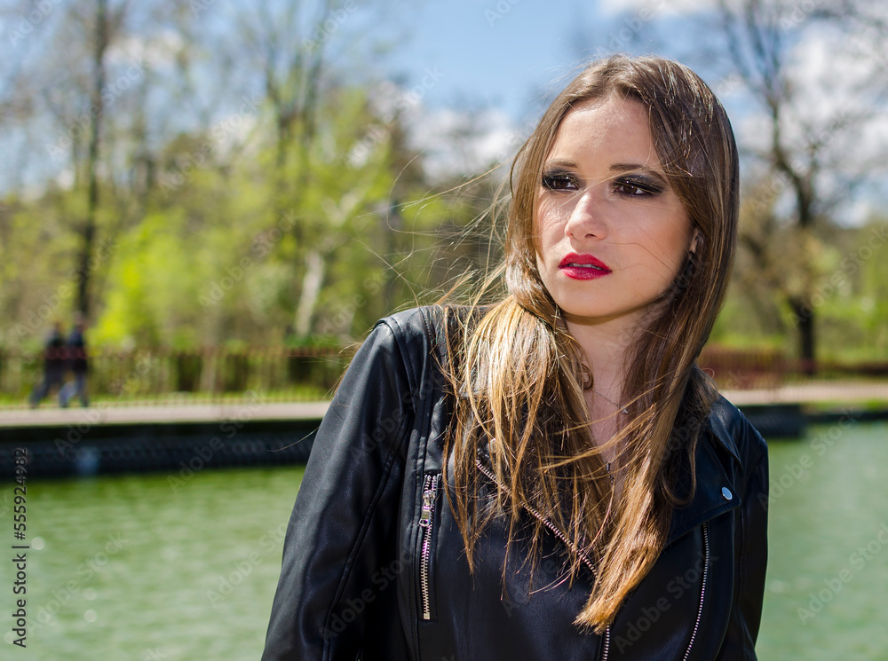 Portrait of a woman outdoors background with leather jacket Portrait of a woman outdoors background with leather jacket