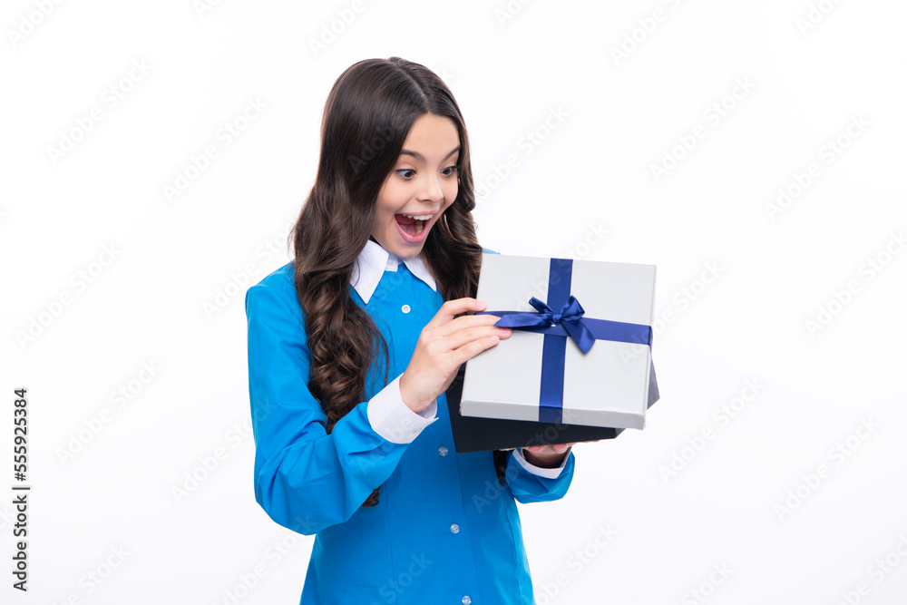 Surprised emotions of young teenager girl. Teenager kid with present box. Teen girl giving birthday gift. Present, greeting and gifting concept. Surprised emotions of young teenager girl. Teenager kid with present box. Teen girl giving birthday gift. Present, greeting and gifting concept.