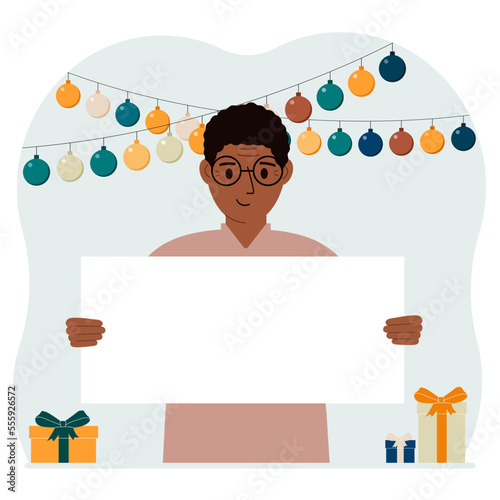 Holiday concept with garland, gift boxes and poster. A man smiles, rejoices and celebrates a birthday, a festive event, a victory, an achievement or a holiday.