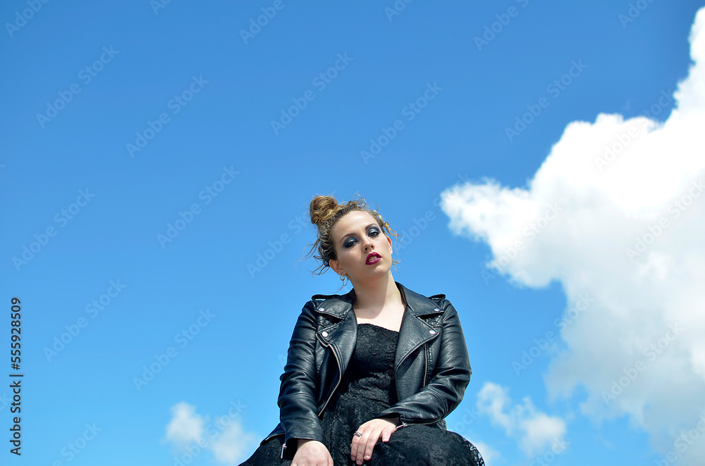 Curly blond hair woman outdoors sky background Curly blond hair woman outdoors sky background