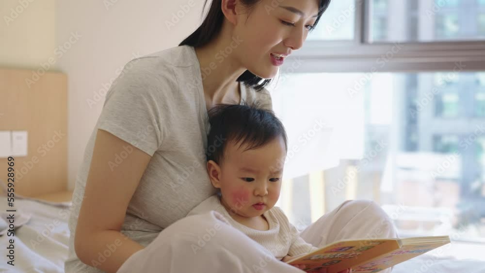 Young Chinese mother spending time with her baby Young Chinese mother spending time with her baby