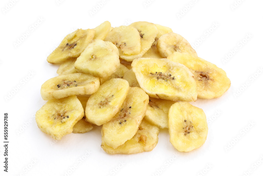 Heap of dried bananas on the white background. Sweet snacks Dried banana slices. organic dried banana chips close up.