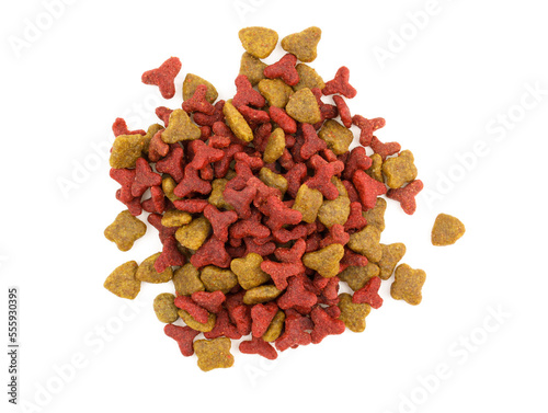 Dry meat food for pets on a white background. Heap of red dry dog food top view. Daily diet for pets. Dry cat food on a white background.