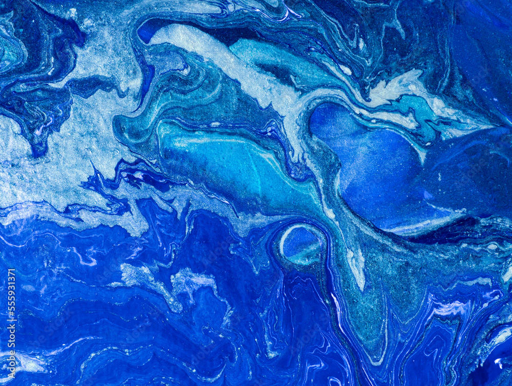 liquid acrylic fluid art close up.  Blue liquid marble effect, modern fluid art. Blue and gold abstract painted background. Drawing Creative wallpaper, beautiful design. Waves effect, trendy wash draw