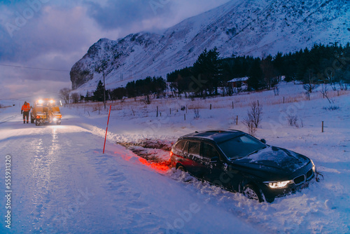 The roadside assistance service pulling the car out of the canal. An incident on a frozen Scandinavian road.