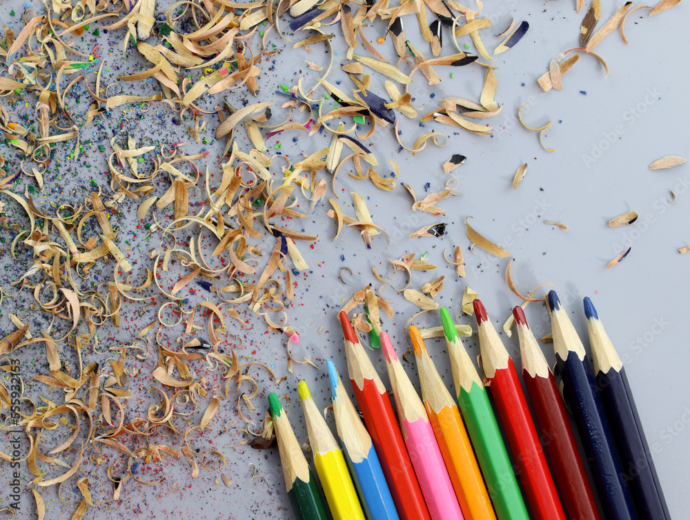 Colored pencils and shavings top view. Closeup drawing pencils