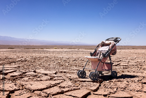 Canvastavla Desertification: symbolic image for climate change - Abandoned stroller on dry s