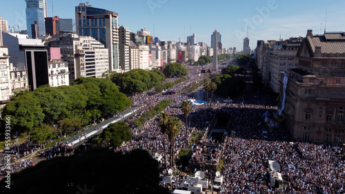 Crowd in Buenos Aires streets full of argentinian supporters. Aerial footage. Argentina wins Qatar 2022 Soccer World Cup. 9 de Julio Avenue and Obelisk at background. photo