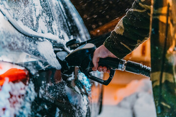 Refuelling diesel gas on petrol station at winter