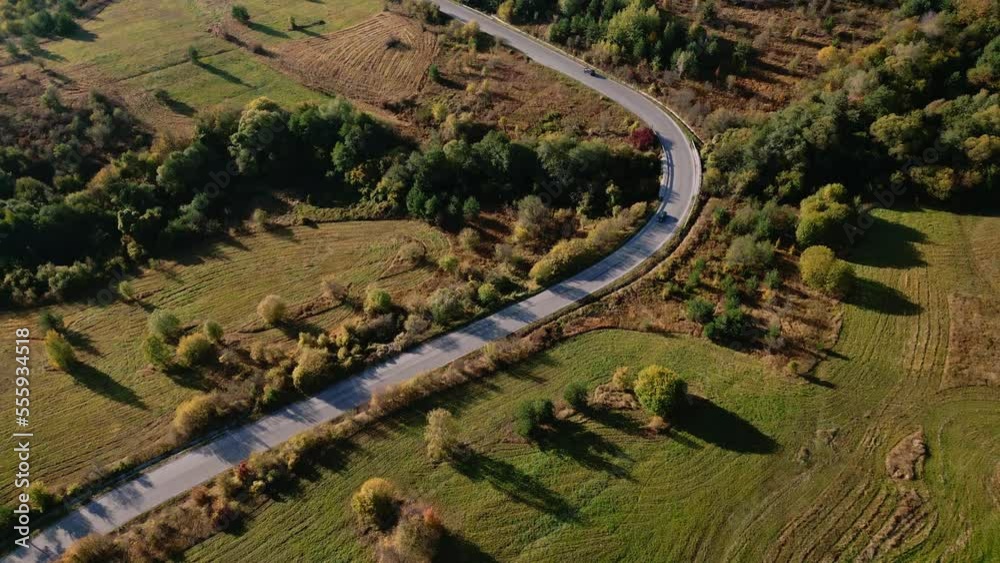 Aerial drone shot of a twisty mountain road on a sunny morning by autumn. Colorful landscape. Aerial drone shot of a twisty mountain road on a sunny morning by autumn. Colorful landscape.