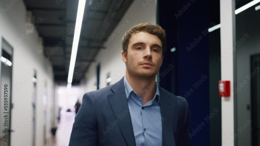Pensive employee walking office hallway closeup. Tired man executive leaving Pensive employee walking office hallway closeup. Tired man executive leaving