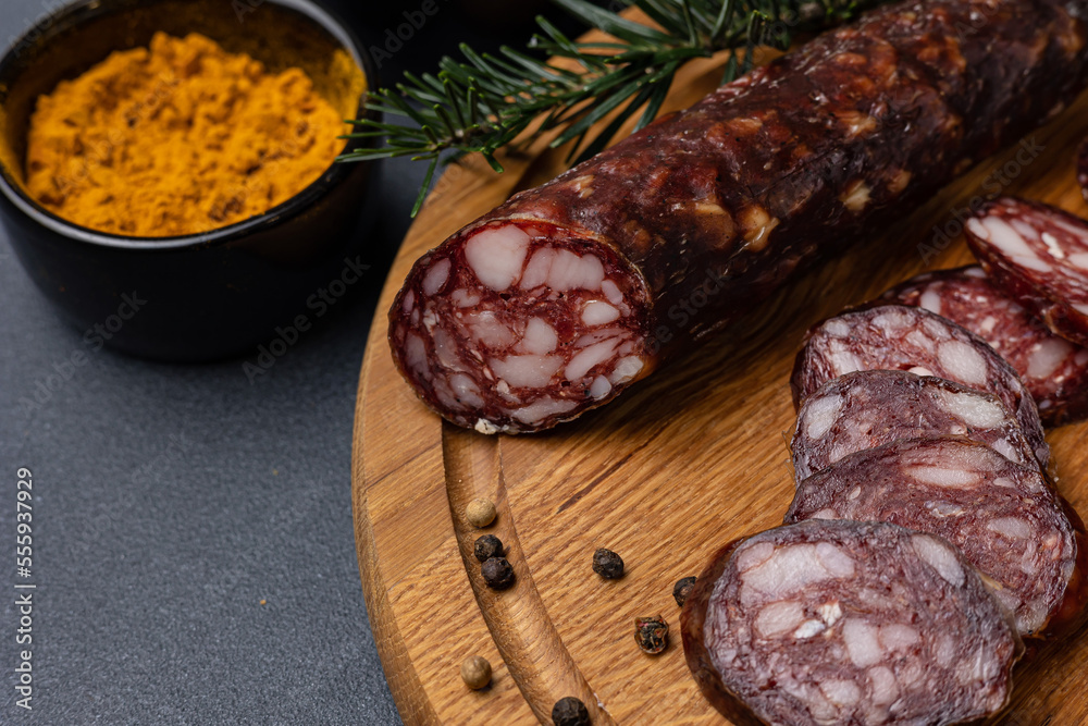 Traditional meat delicacies, sausages on a dark table
Traditional meat delicacies, sausages on a dark table