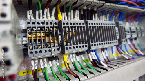 The wires and terminals in the electrical control cabinet that are connected are circuits for controlling machinery within the industrial plants. The concept of automatic and industrial system