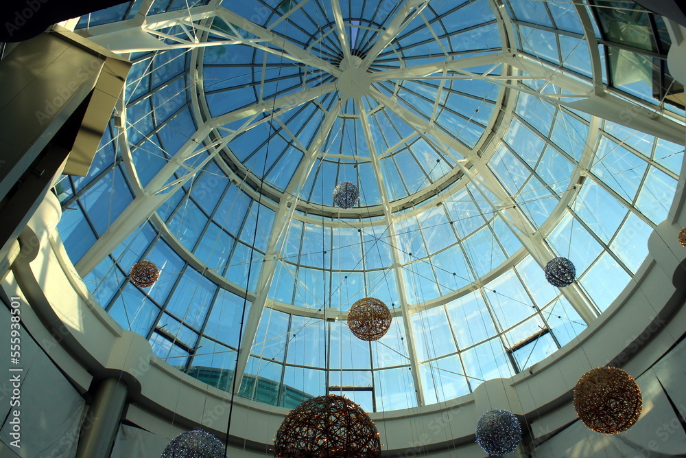 Christmas festive shiny balls hang under the dome in the mall.