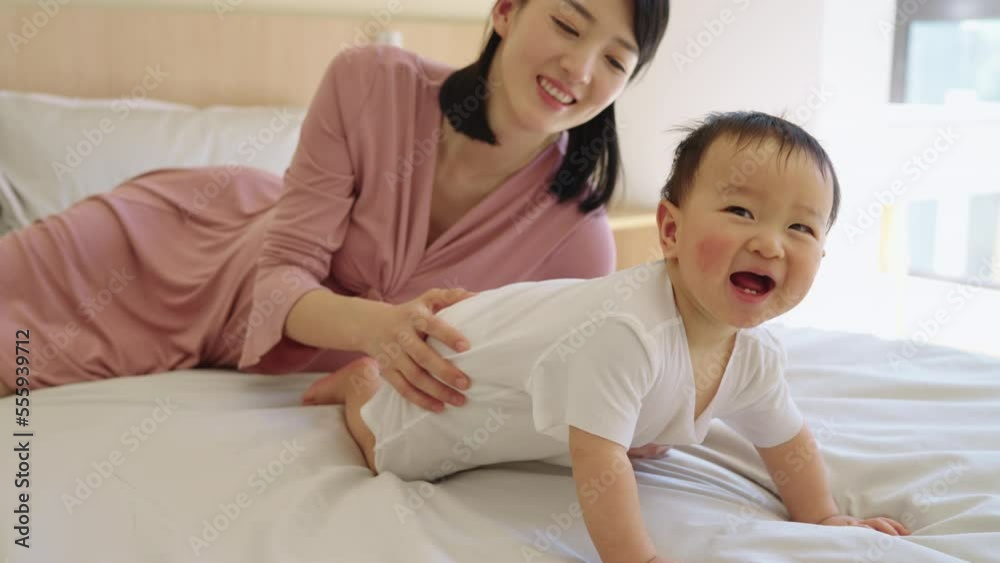 Young Chinese mother spending time with her baby Young Chinese mother spending time with her baby