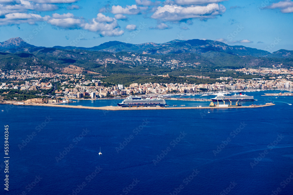 Aerial view of Mallorca Island with coast and ships seen through window of plane on a sunny autumn day. Photo taken October 9th, 2022, Mallorca, Spain.