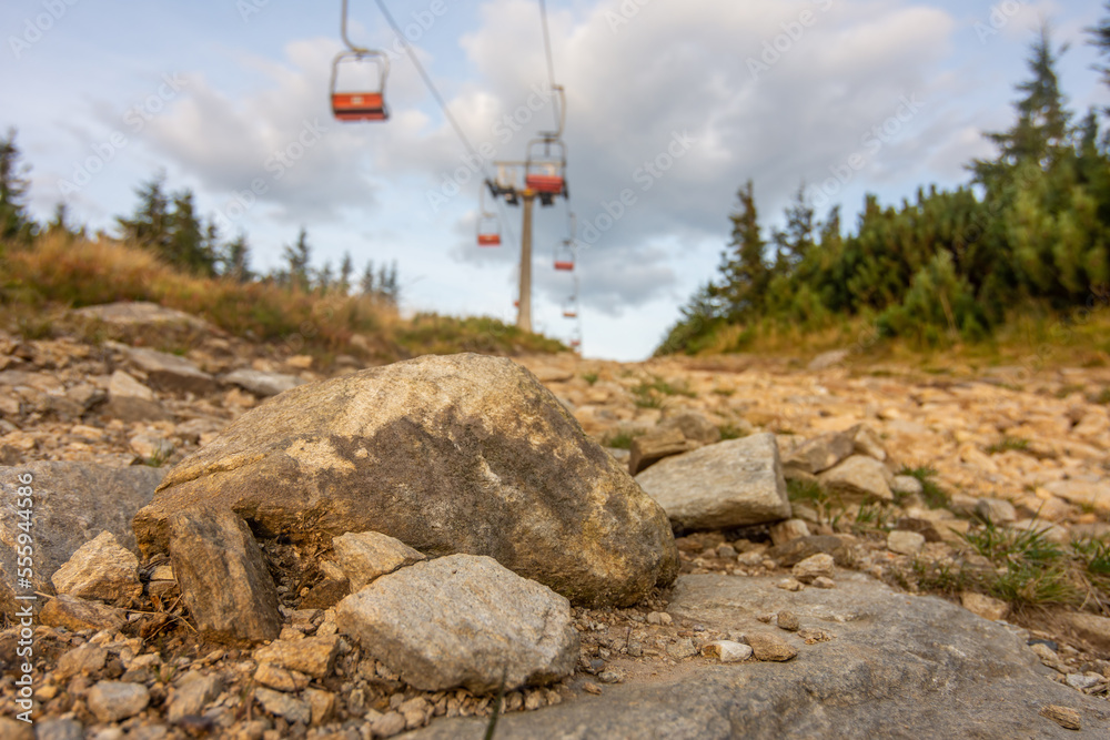 Fototapeta premium Close-up of stone and chairlift in the Jeseniky mountains in the Czech republic to the Serak mountain peak.