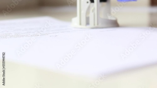 Wallpaper Mural A man's hand signs a document with a pen and puts a stamp, seal Torontodigital.ca