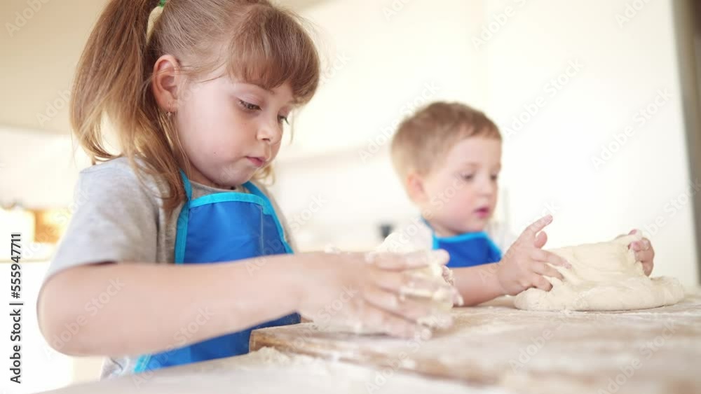 kids are baking. children knead dough and flour in the kitchen. happy family kid concept. baby children bake pizza dough. brother sister baking cookies. teamwork children knead dough and flour dream kids are baking. children knead dough and flour in the kitchen. happy family kid concept. baby children bake pizza dough. brother sister baking cookies. teamwork children knead dough and flour dream