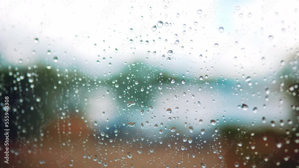 raindrop on the window in autumn a background. wet glass rain drops rainy sky blurred background close-up. rain in the window lifestyle on the background of the sky blurred plan raindrop on the window in autumn a background. wet glass rain drops rainy sky blurred background close-up. rain in the window lifestyle on the background of the sky blurred plan