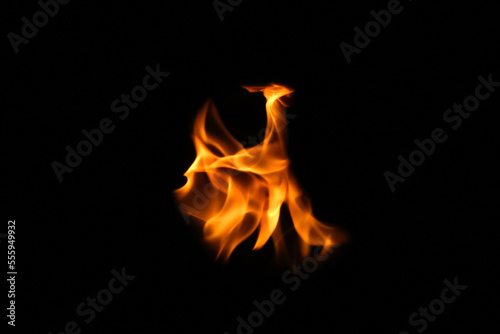 Defocus fire flames. Eagle silhouette Fire embers particles over black background. Fire sparks background. Abstract dark glitter fire particles lights. bonfire in motion blur. Out of focus © tanitost