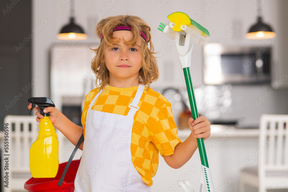 Children helping with housekeeping, cleaning the house. Housekeeping at home. Cute child boy helping with housekeeping on kitchen interior backdround. Children helping with housekeeping, cleaning the house. Housekeeping at home. Cute child boy helping with housekeeping on kitchen interior backdround.