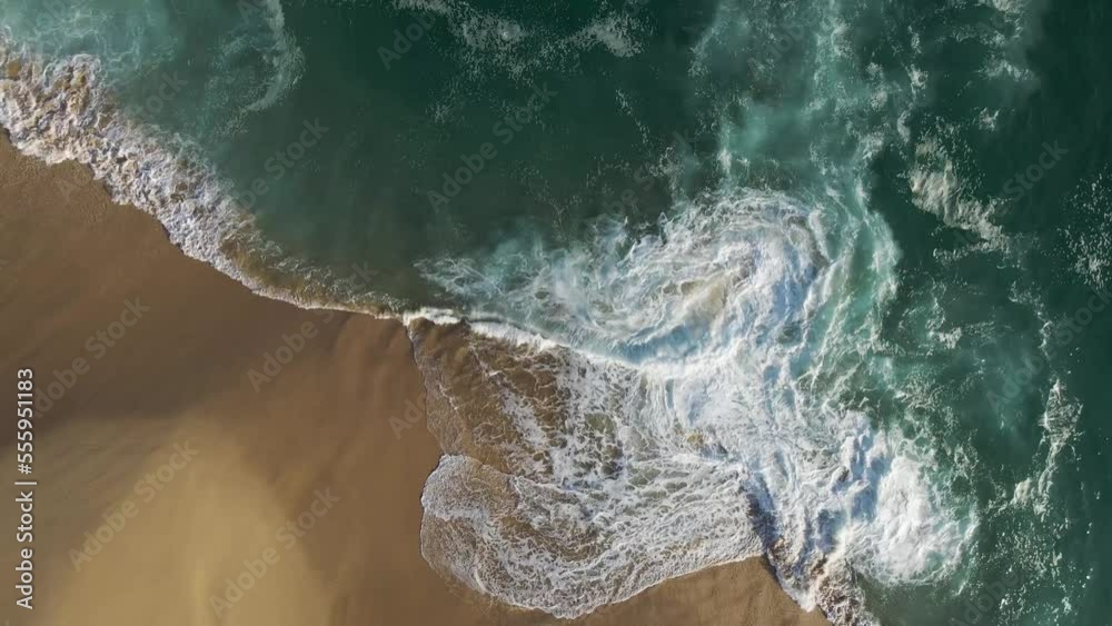 Aerial view of waves breaking on the shoreline at Playa del Divorcio, Cabo San Lucas, Baja California, Mexico.