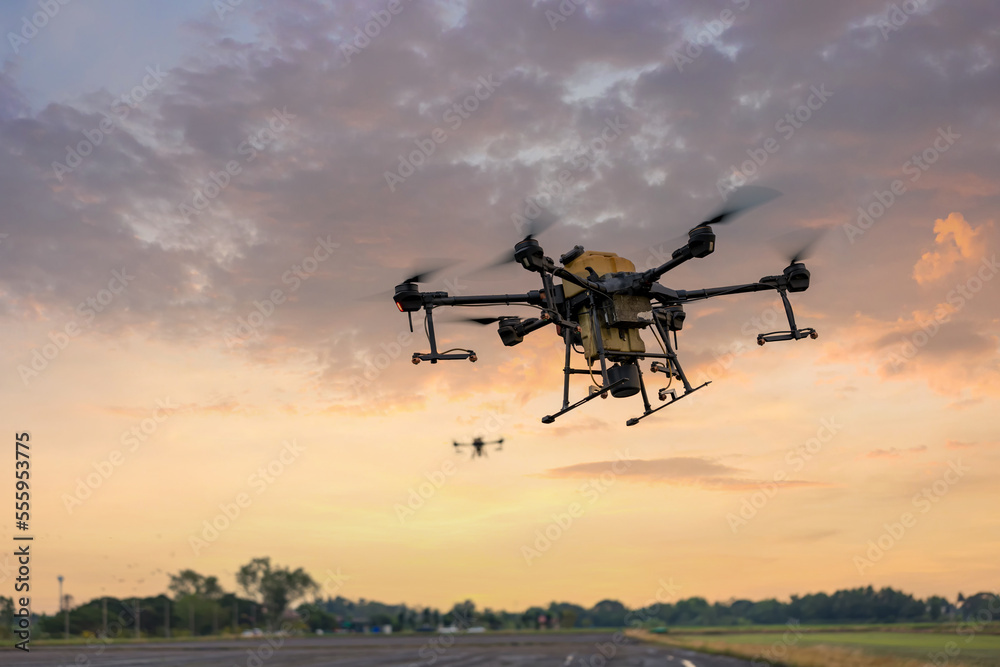 Modern smart farm with drone. Agriculture drone fly to Ready spray fertilizer on the rice fields. Modern smart farm with drone. Agriculture drone fly to Ready spray fertilizer on the rice fields.